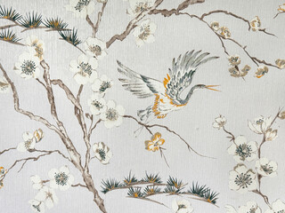 Close up of floral tree branches and bird theme printed wallpaper. Suitable for wall covering and other graphic background. Seamless background texture.