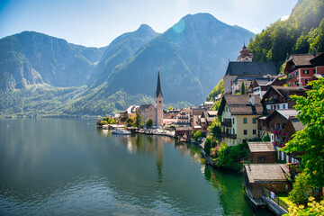 Fototapeta premium Picturesque view of Hallstatt city and lake, surrounded by stunning alpine mountains and serene waters