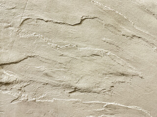 Close up of natural white beige stone granite with 3D texture. Giant beige rock stone slab, natural pattern suitable for floor and wall material finishes. Seamless background texture.