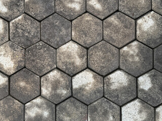 Hexagon outdoor paving stone tiles, with semi wet stone right after rain. Pavement texture...