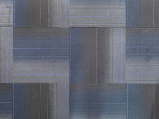 Close up of blue and black tone carpet tile in chevron pattern. Dark blue, light blue, and dark grey color combination suitable for class and office carpet flooring. Seamless background texture