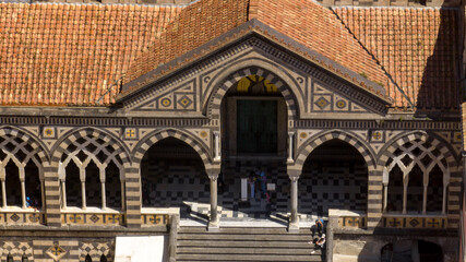Obraz premium Closeup of the entrance to the Amalfi Cathedral, in the province of Salerno, in Campania, Italy. The church, dedicated to St. Andrew the Apostle, is built in Romanesque, Baroque and Rococo style.