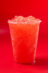 Red strawberry slushie on red background