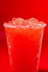 Red strawberry slushie on red background