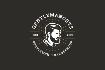 Stylish barbershop logo featuring a side profile of a gentleman with beard and mustache, surrounded by golden rays. The design includes text elements and a vintage aesthetic. Vector illustration