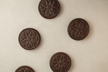 Delicious dark chocolate cookies arranged playfully on a neutral surface