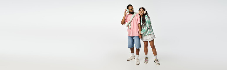 Obraz premium Stylish couple sharing a moment of joy in a minimalist studio setting