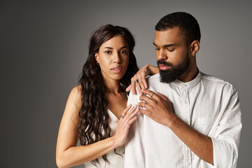 Stylish couple embracing elegance in a contemporary setting during golden hour