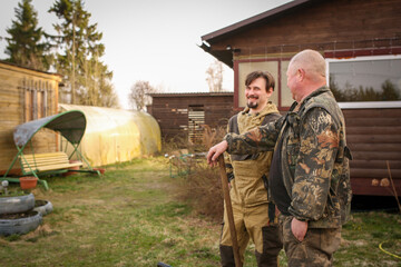The eldest son helps his father to improve the dacha plot. Family pastime on Father's Day. 