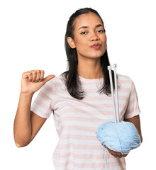 Young Filipina holding yarn feels proud and self confident, example to follow.