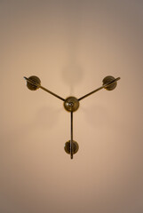 Chandelier style electric light fitting on a ceiling seen directly from below. Portrait view.