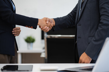 Business men and women shake hands confidently professional investor working with new startup...