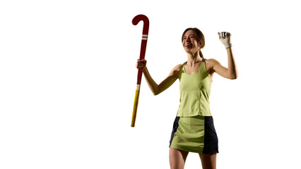 Victory pose with raised stick and joyful expression on green grass field against white studio background. Celebration of triumph. Concept of sport events, competition, championship, game, movements.
