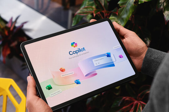 Office worker using microsoft copilot on a tablet for everyday ai assistance