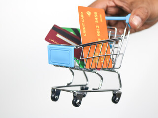 Mini shopping cart and credit cards is in the shopping cart for present about spend money by credit...