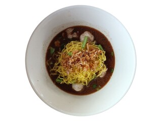 Noodles with pork and vegetable in white bowl on wooden table
