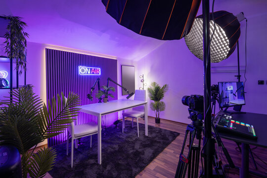 Modern podcast recording studio with professional lighting