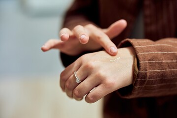 Applying Lotion on Hand for Skin Care and Hydration