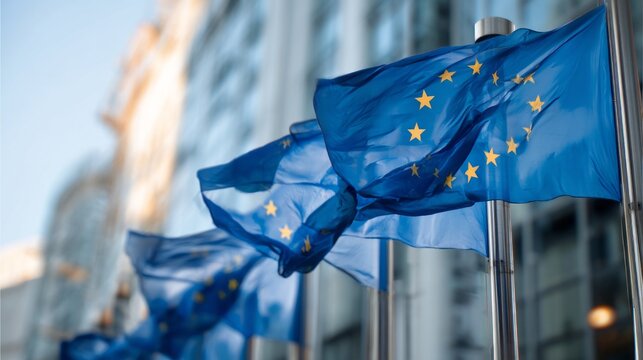 european union flags waving in front of building.