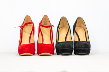 black and red pumps next to each other with a white background
