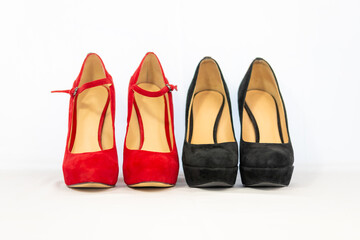 black and red pumps next to each other with a white background