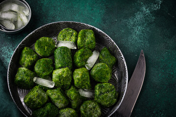 Frozen spinach green cubes in bowl