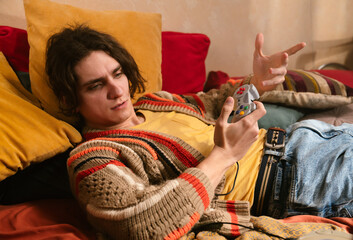 Young Man Playing While Lying Down On A Game Console
