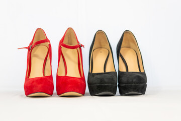 black and red pumps next to each other with a white background