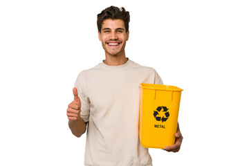 Young caucasian man holding a metal trash for recycle Young caucasian man holding recycling bins...