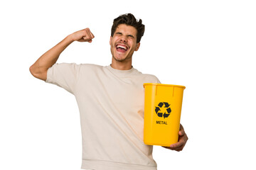Young caucasian man holding a metal trash for recycle Young caucasian man holding recycling bins...