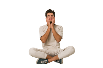 Young caucasian man sitting on the floor isolated on white background whining and crying disconsolately.
