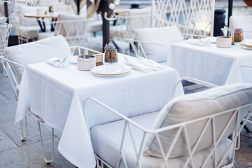 Elegant outdoor seating near a fountain in a vibrant urban plaza during evening hours
