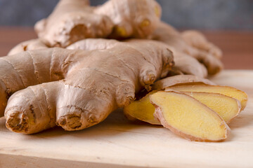 Cup of tea with ginger root on a wooden table, Ginger tea with and honey on a gray background.