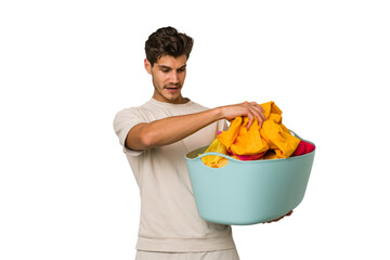 Young caucasian man doing laundry isolated on white background