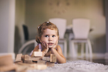 Cute baby girl playing with wooden blocks