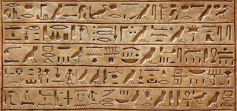 Old Egyptian hieroglyphs on an ancient background. Wide historical and culture background. Ancient Egyptian hieroglyphs as a symbol of the history of the Earth.