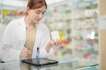 A woman pharmacist inspects a medication bottle, ensuring accuracy in prescription filling. pharmacists in patient safety and careful medication handling. daily operations in a modern pharmacy.