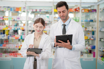 team man and woman pharmacist inspects a medication bottle, ensuring accuracy in prescription...