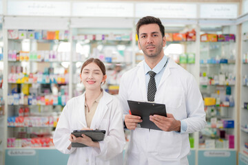 team man and woman pharmacist inspects a medication bottle, ensuring accuracy in prescription...