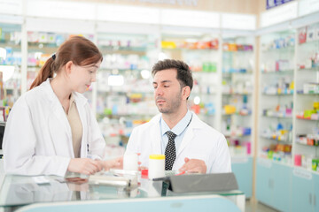Fototapeta premium team man and woman pharmacist inspects a medication bottle, ensuring accuracy in prescription filling. pharmacists in patient safety and careful medication handling. operations in retail pharmacy.