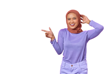 Portrait of smiling young Asian woman pointing finger at copy space isolated on transparent background