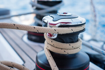 Sailing yacht ropes and winch. Sailboat equipment details. Water transport, marine travel lifestyle...