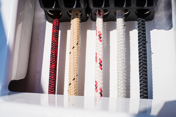 Sailing yacht ropes, stopper and winch. Sailboat equipment details. Water transport, marine travel lifestyle vacation theme.