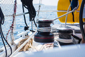Sailing yacht ropes and winch. Sailboat equipment details. Water transport, marine travel lifestyle vacation theme.