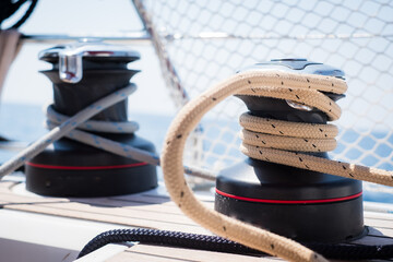 Sailing yacht ropes and winch. Sailboat equipment details. Water transport, marine travel lifestyle...