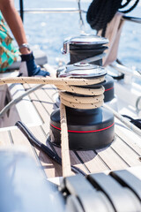 Sailing yacht ropes and winch. Sailboat equipment details. Water transport, marine travel lifestyle vacation theme.