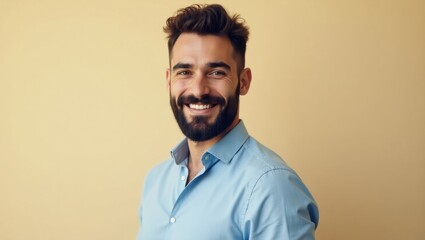 Fototapeta premium Total SE. Smiling bearded man blue shirt casual portrait beige backgro