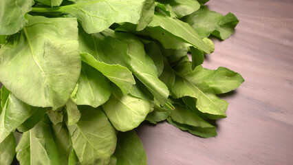 Bundle of fresh spinach isolated on wooden background. Vegan food lifestyle concept, Copy space.