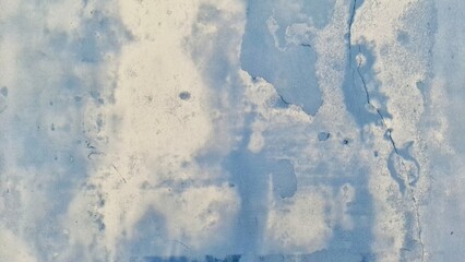 An abstract close-up of a textured surface resembling ice or frosted glass. The image features varying shades of blue and white, creating a serene and ethereal atmosphere.