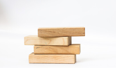 A pile of four wooden blocks on the soft white background.